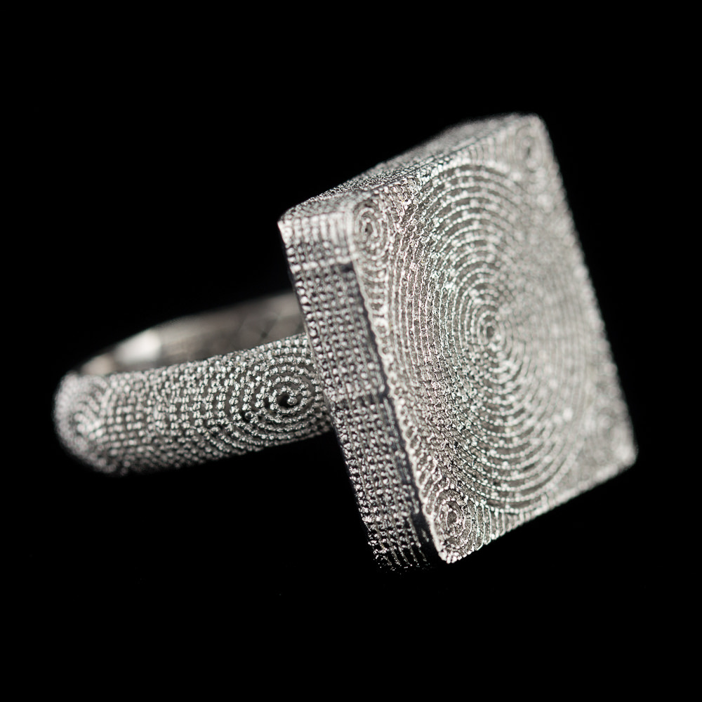 Finely worked out square ring of silver