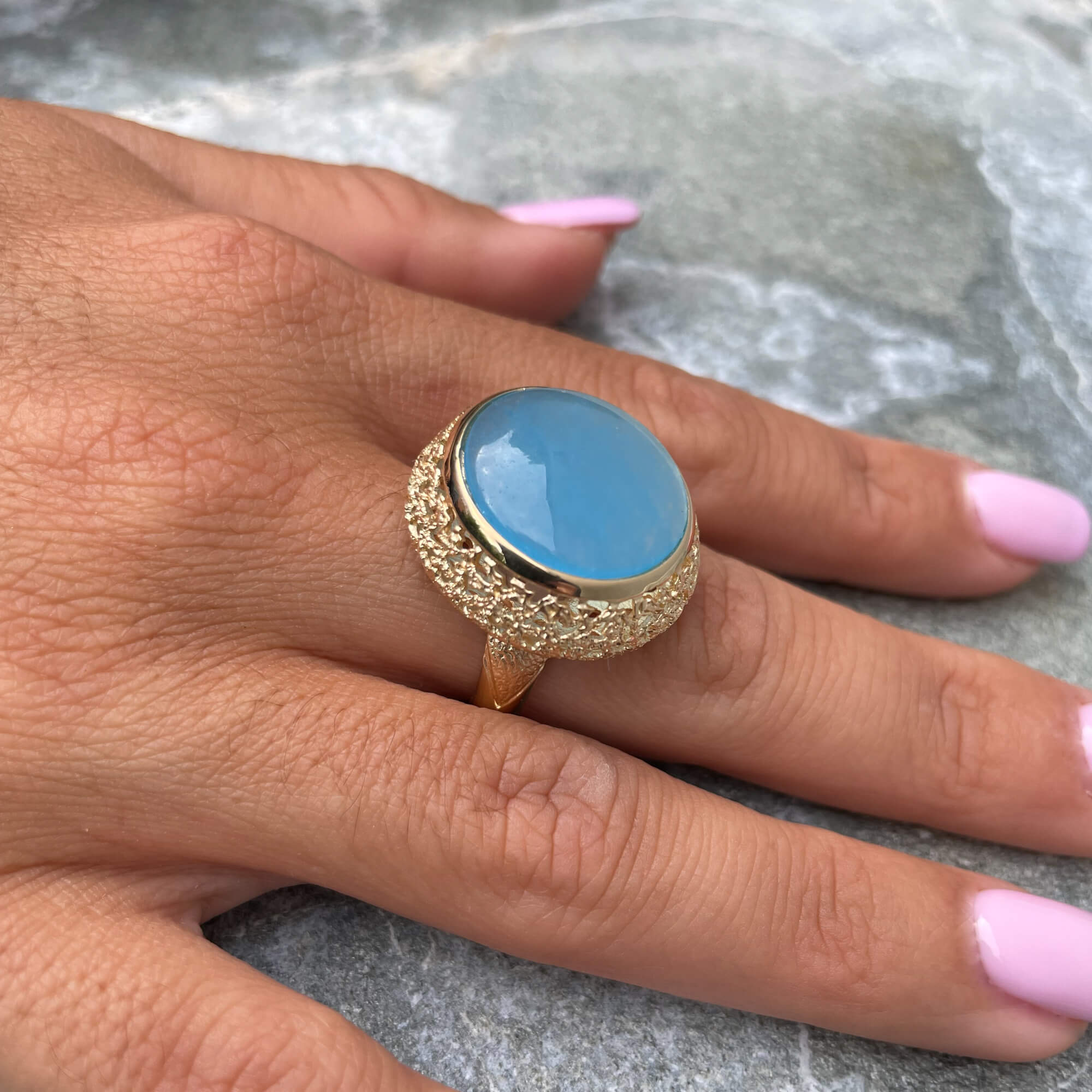 Decorated gold-plated ring with a blue quartz stone