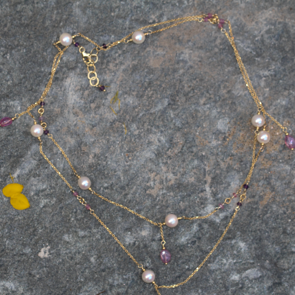 Long gold pearl necklace with gemstones