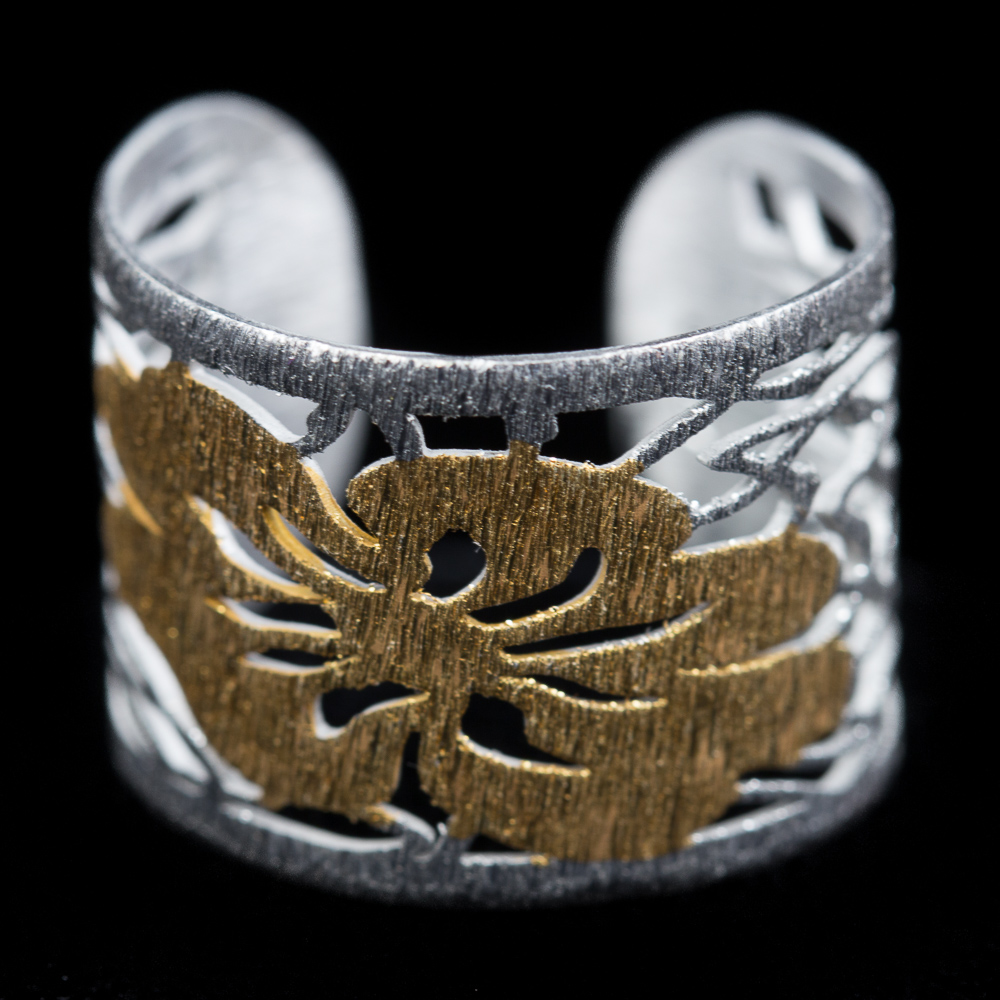 Silver ring with gold plated flower