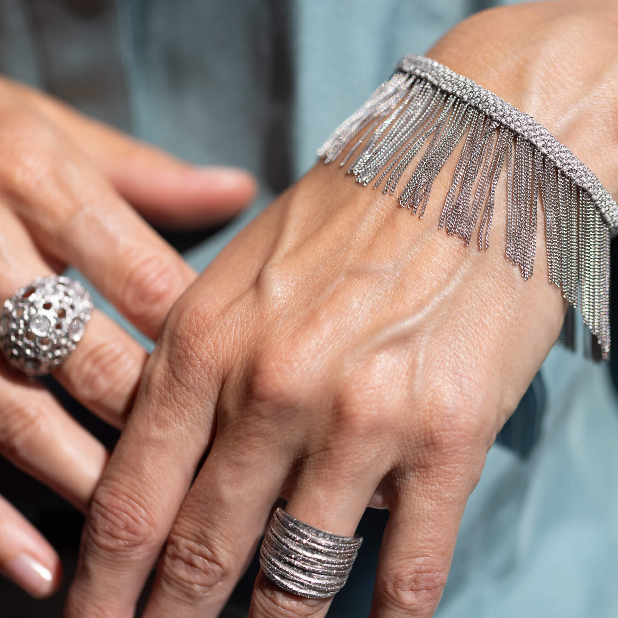 Silver colored bracelet with hanging chains