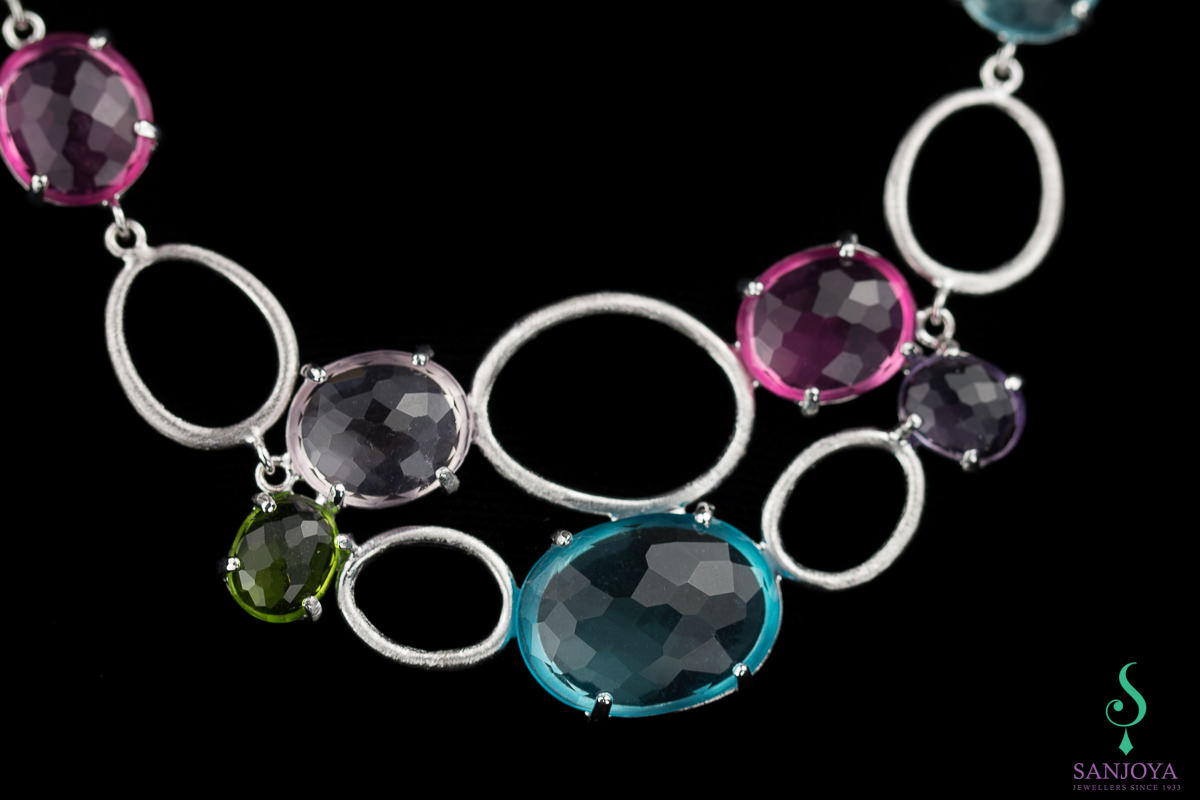 Processed silver necklace with colored stones