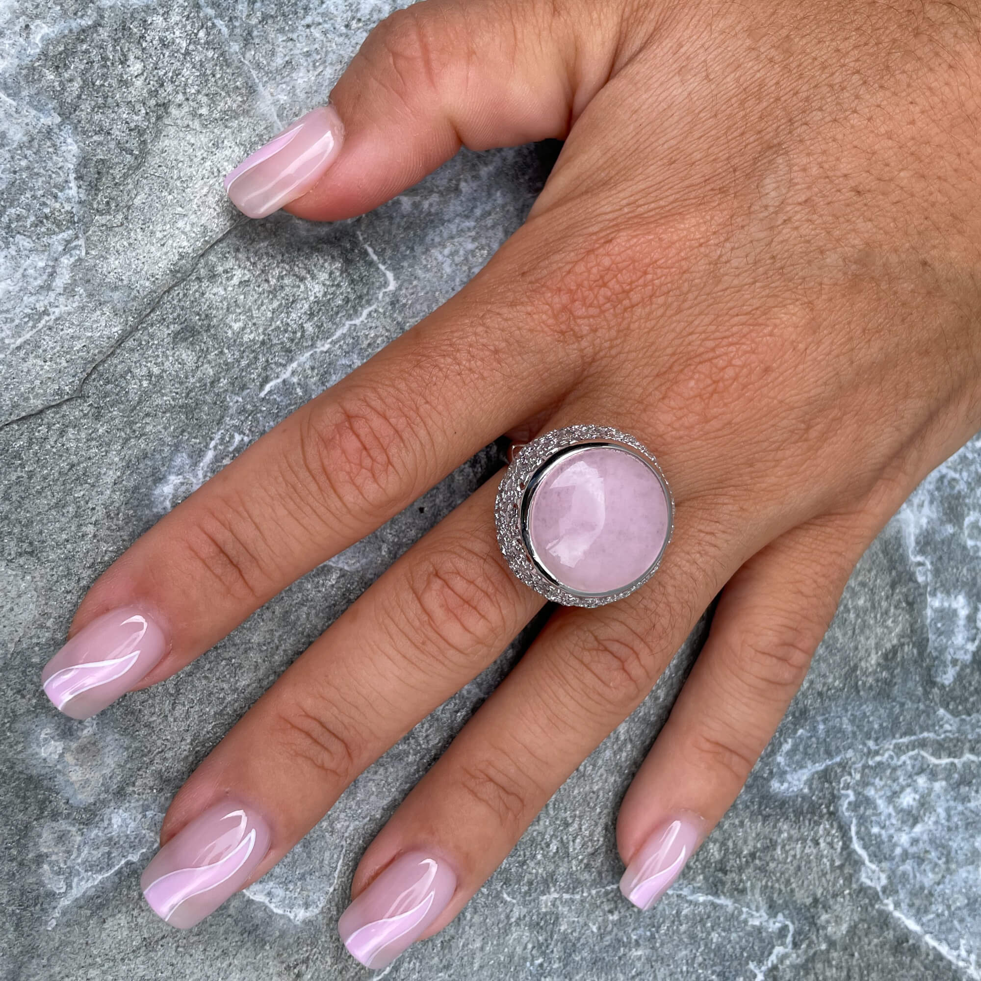 Bewerkte zilveren ring met een roze quartz steen