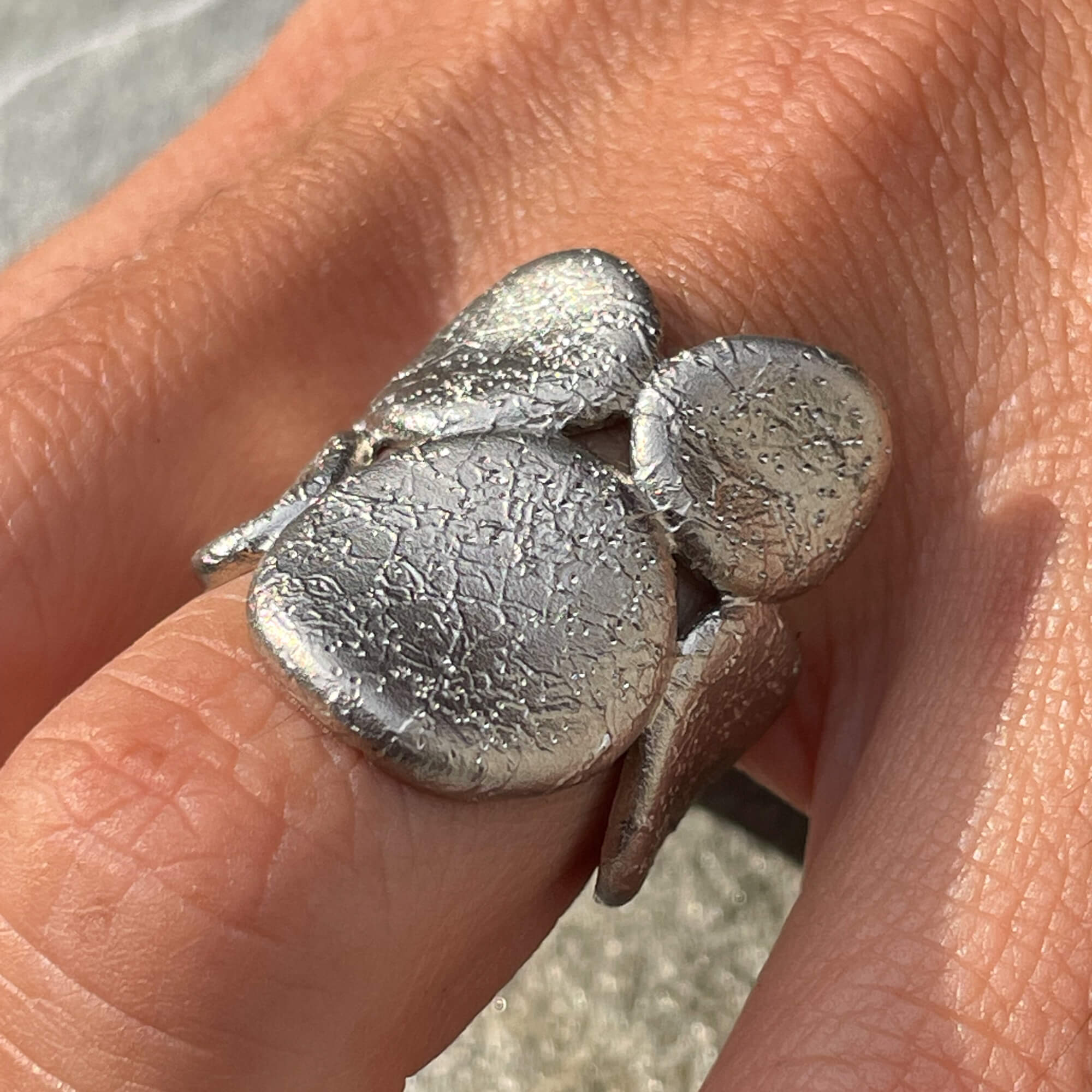 Silver ring with oval-shaped finishes