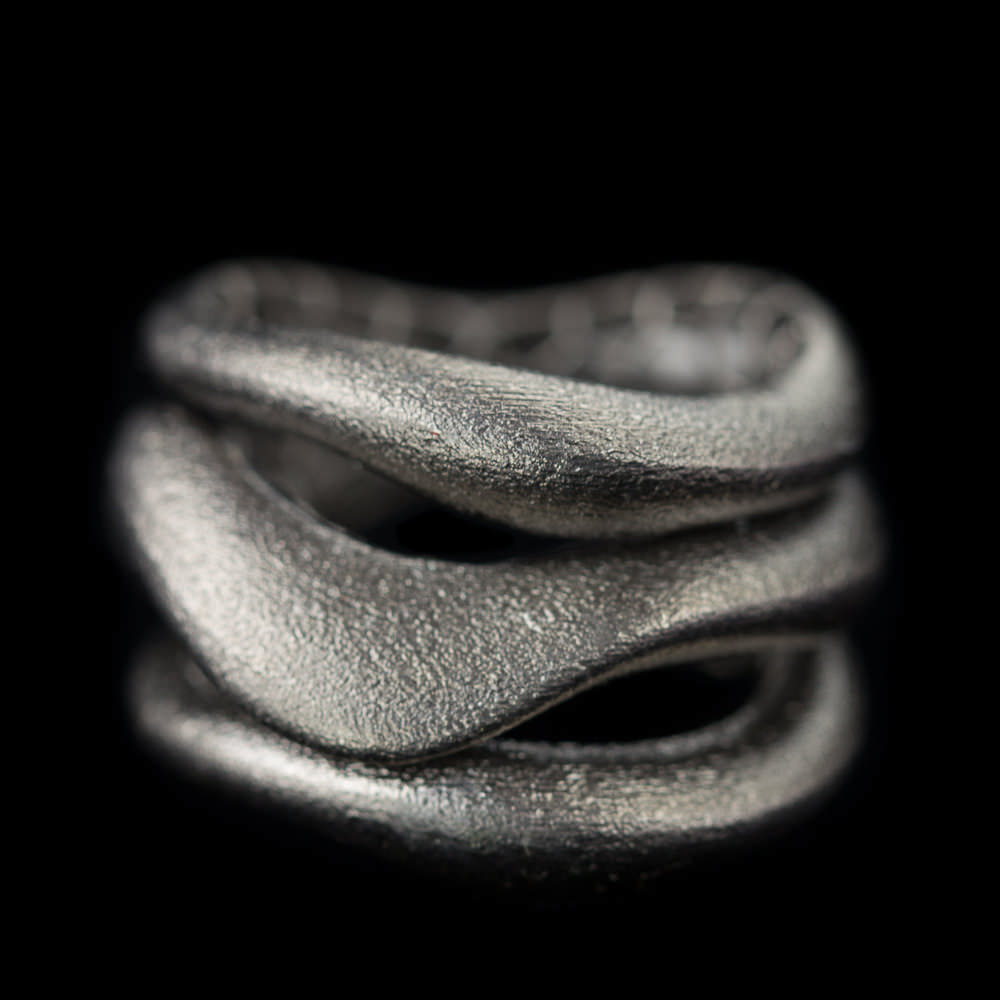 Separate matte ring consisting of three connected rings of dark gray sterling silver. Trendy ring fitting with many jewelry. Also available in the gold-plated; silver and in a tricolor variant. From the Sanjoya collection