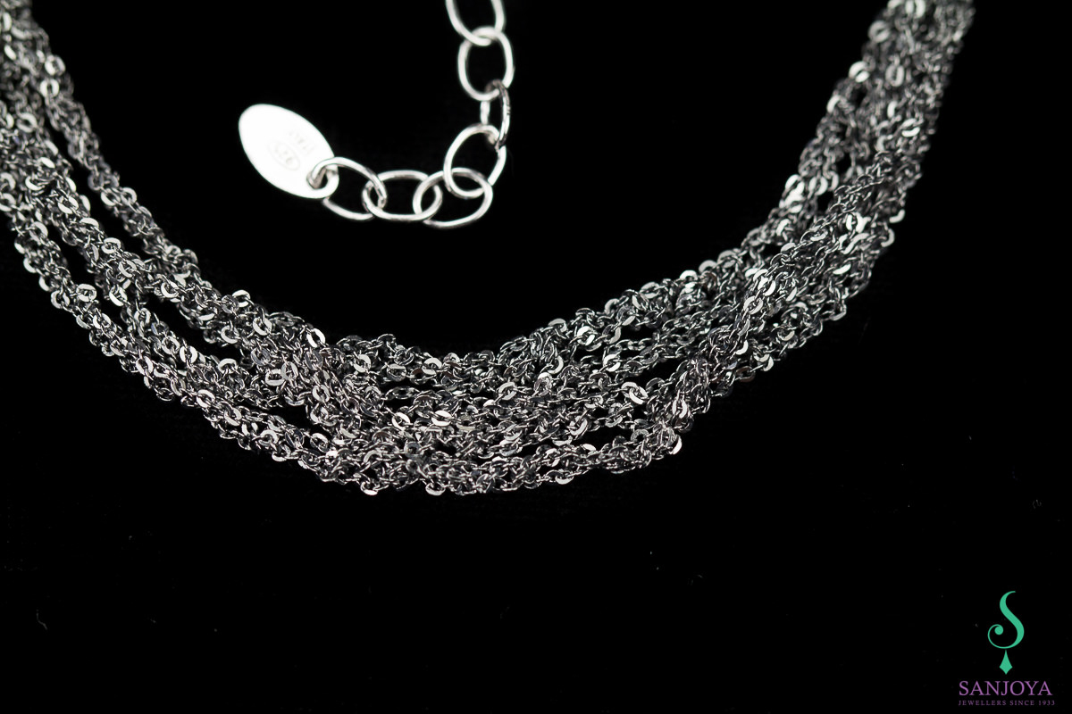 Four interwoven silver bracelets of dark gray