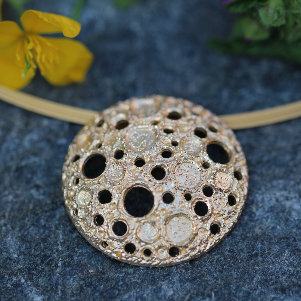 Plated pendant with some stunning holes