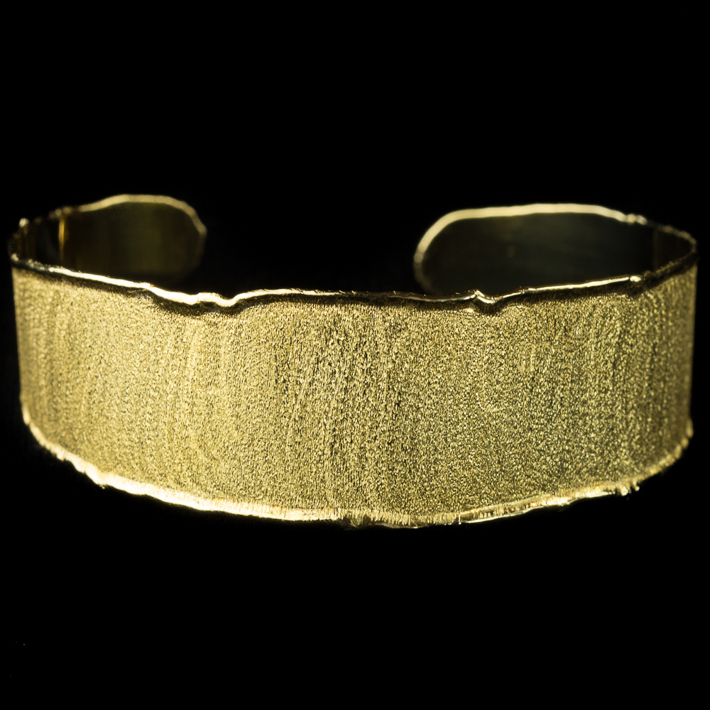 Open cuff bracelet with gold satin glow