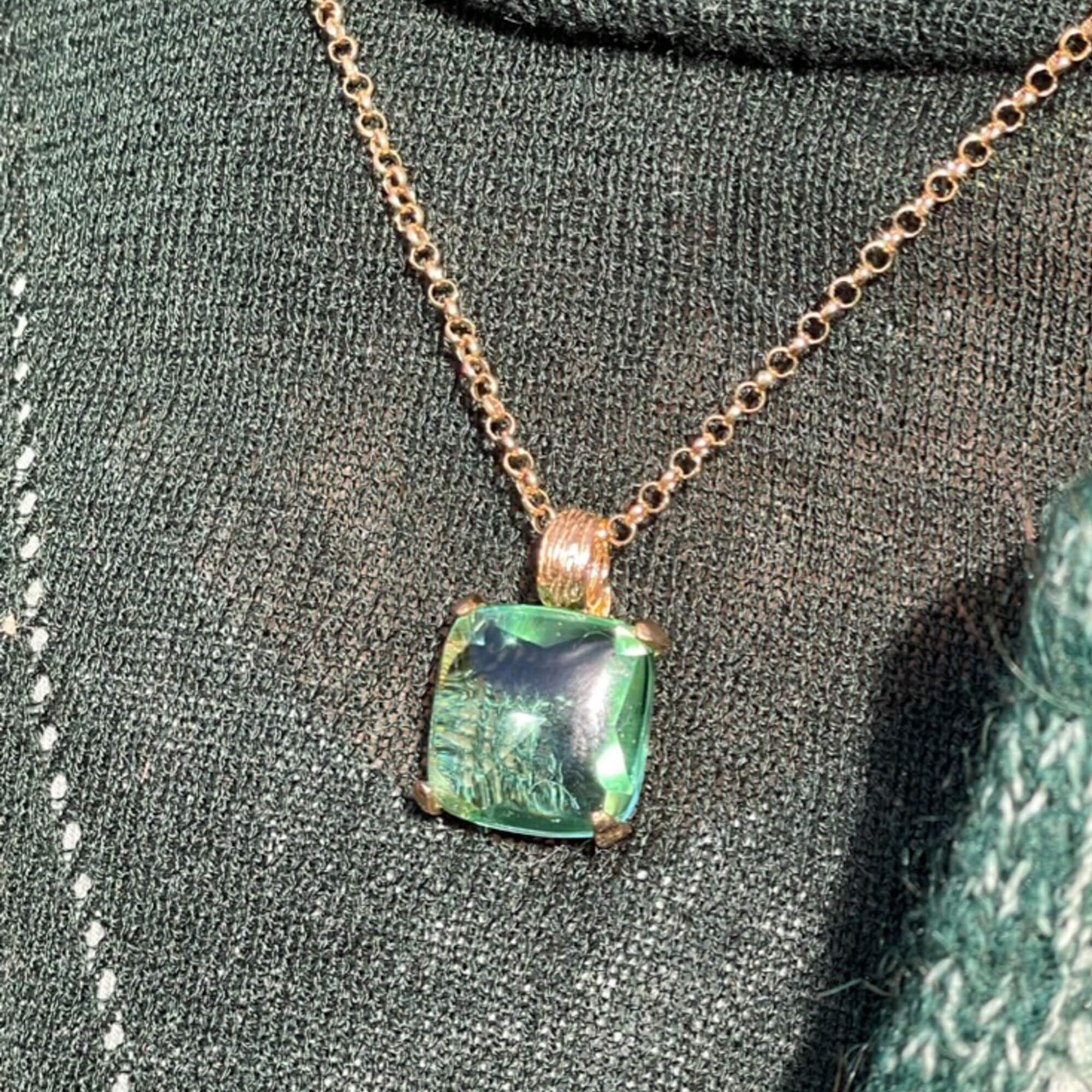 Green square-shaped pendant with gilt chain