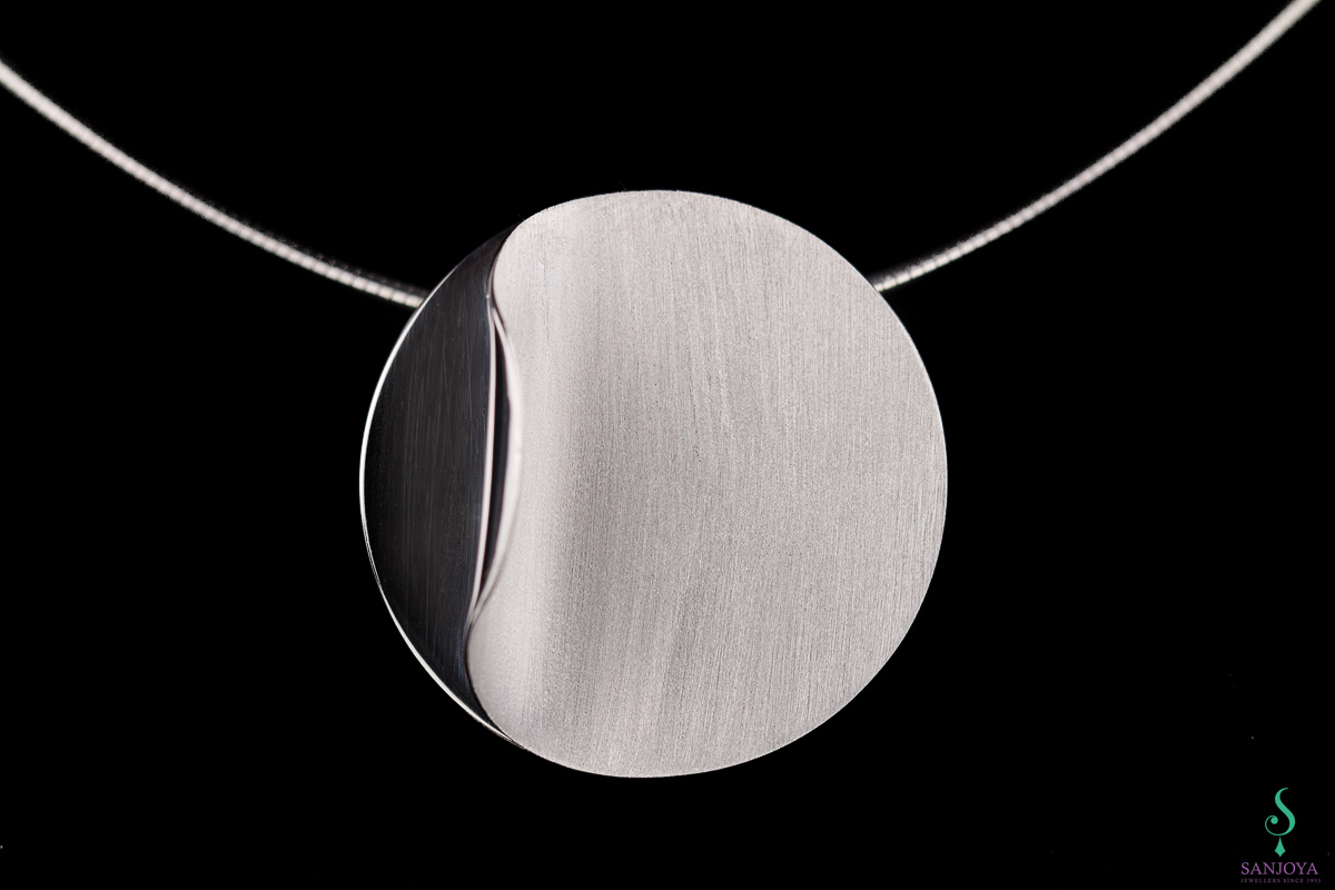 Silver circular pendant with chain & polished curl