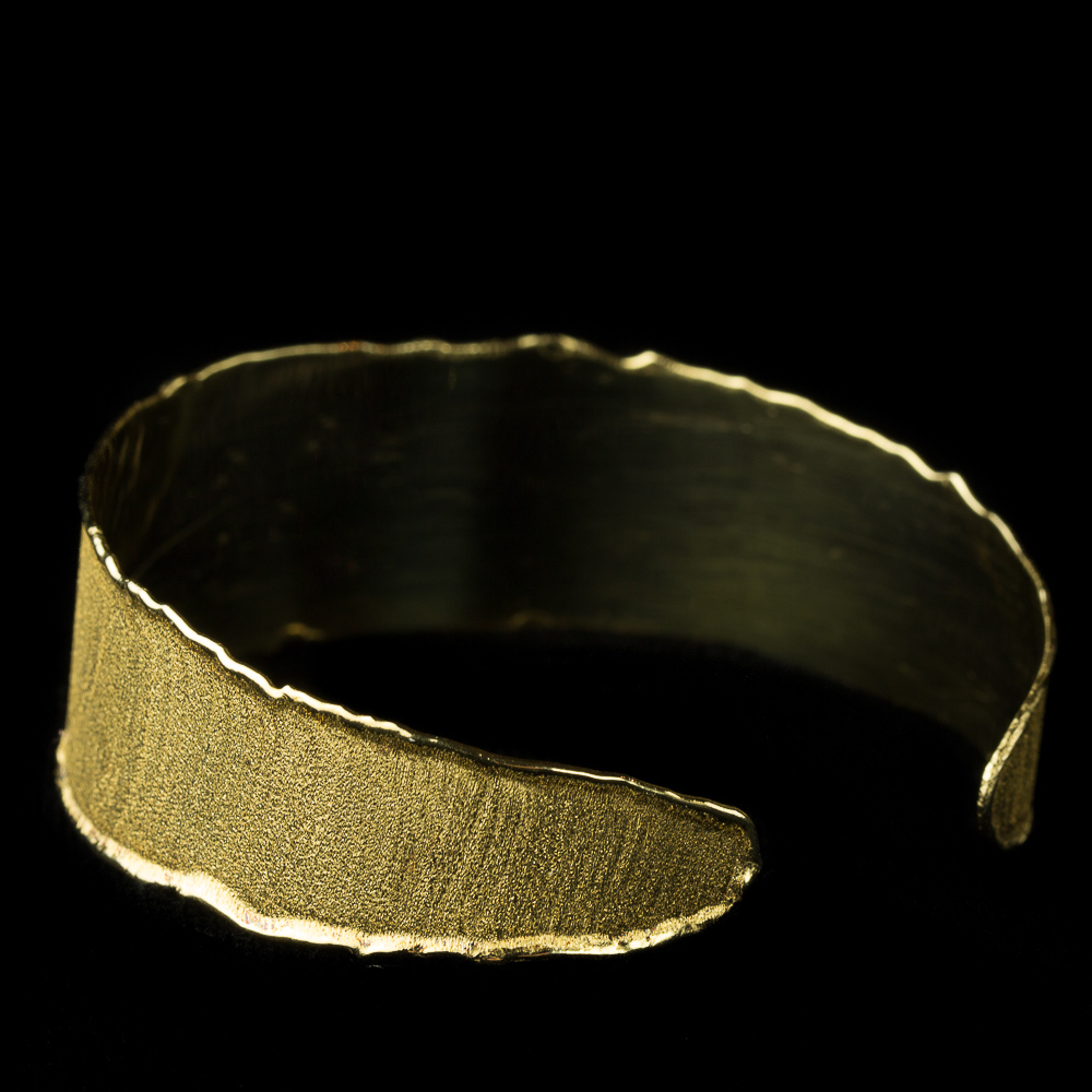 Open cuff bracelet with gold satin glow