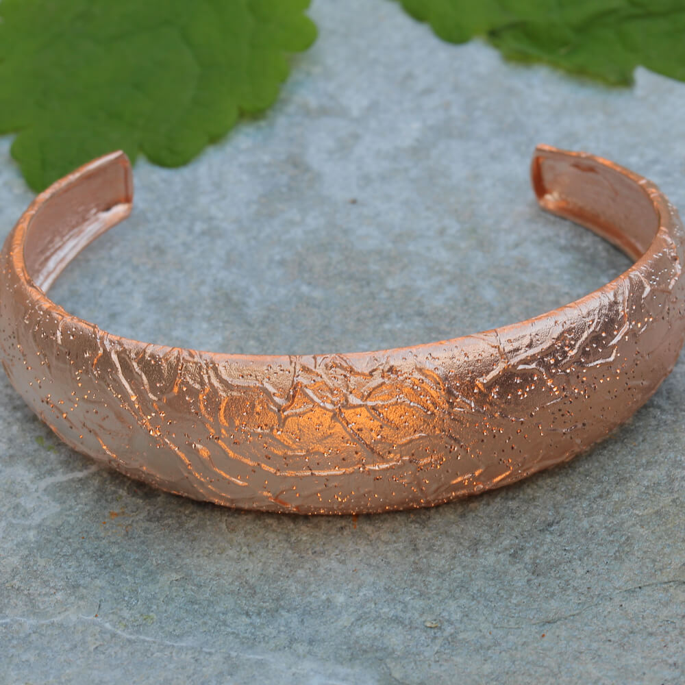 Processed; narrow; and diamond-tipped rosé bangle