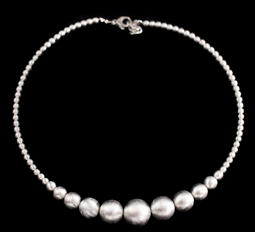Silver necklace of smaller and larger balls