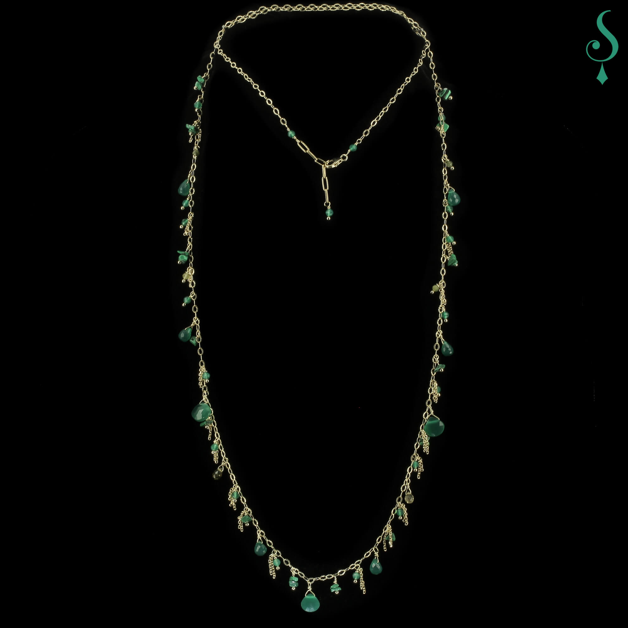 Long gold necklace with green gems