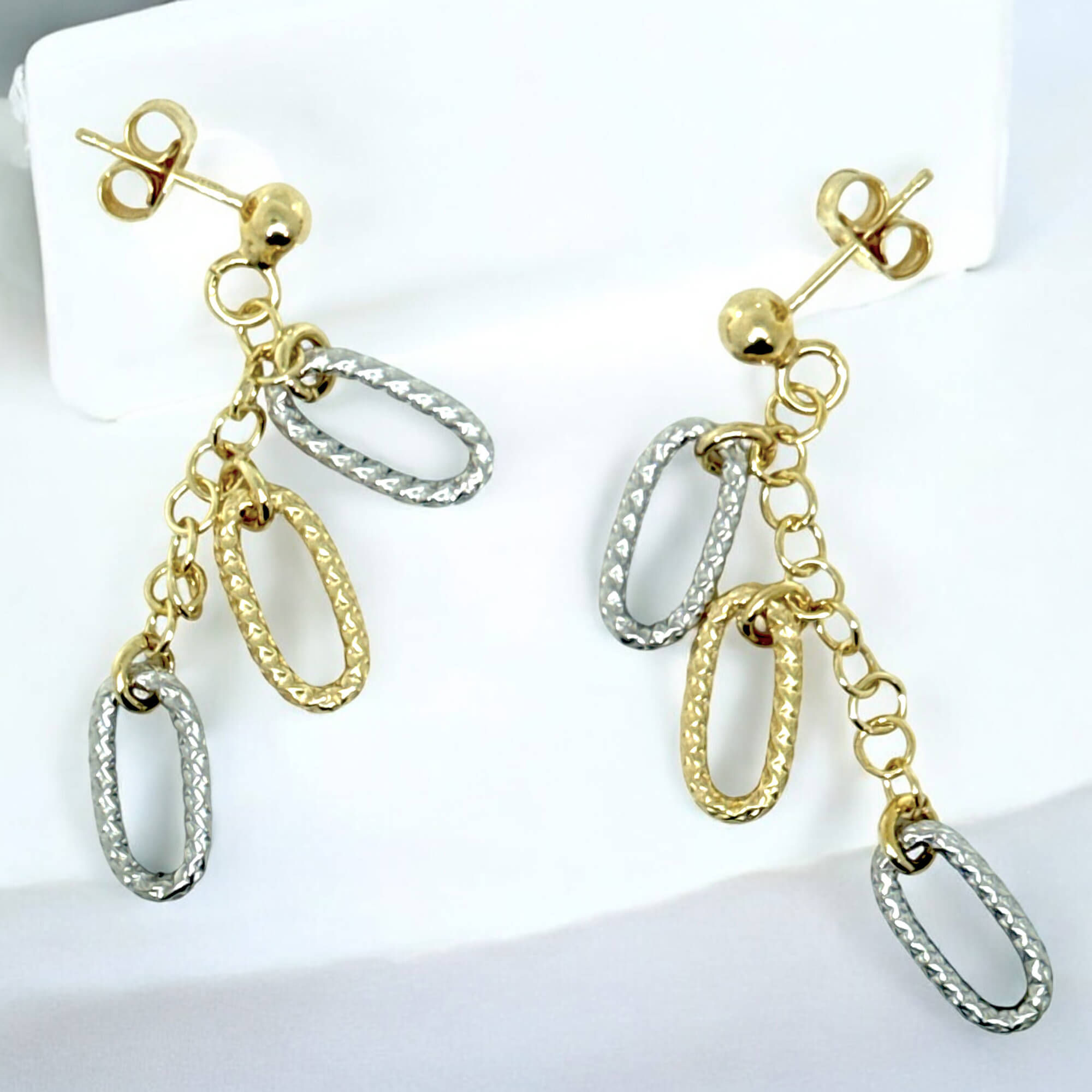 Decorated gold-plated earrings with two-tone pendants