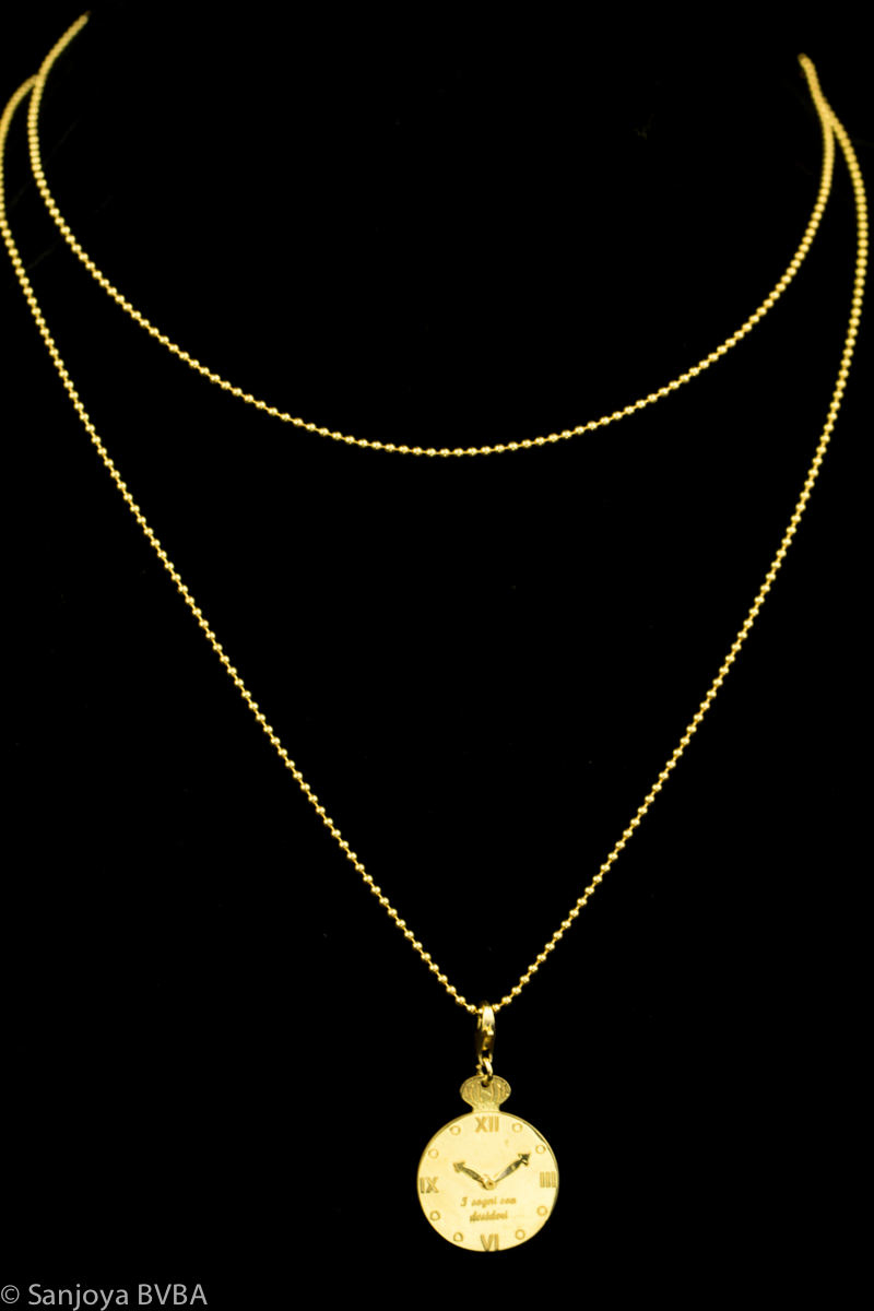 Long gold necklace with pendant bell