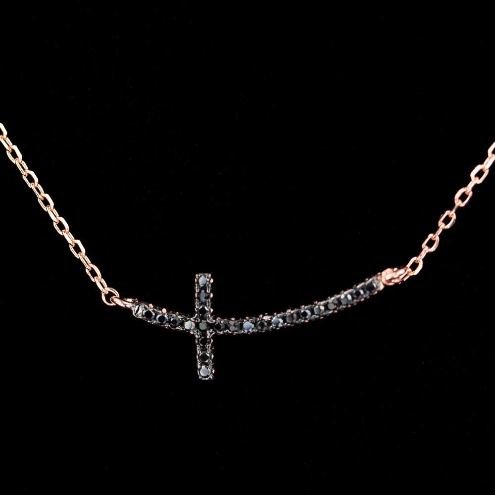 Rose gold necklace with a cross of black zirconia stones