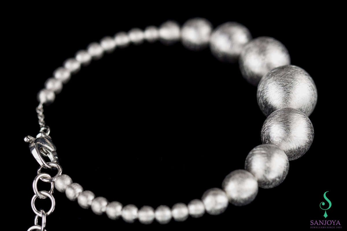 Silver bracelet with small and larger spheres