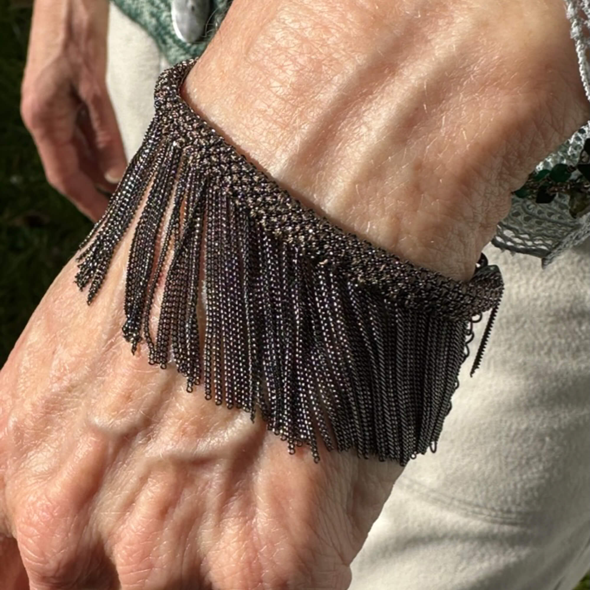 Brown and gray -colored bracelet with hanging chains