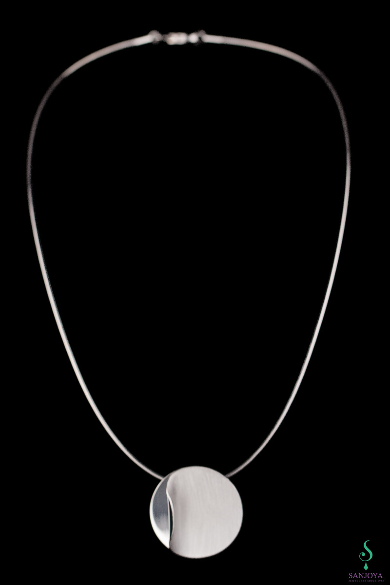 Silver circular pendant with chain & polished curl