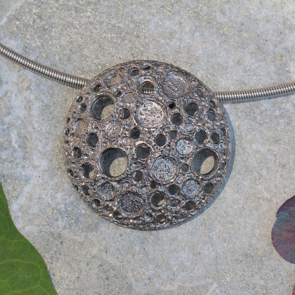 Gray pendant with irregular beautiful holes