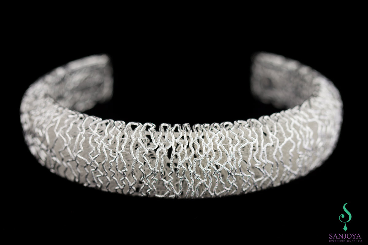Narrow bracelet from white silver and edge work