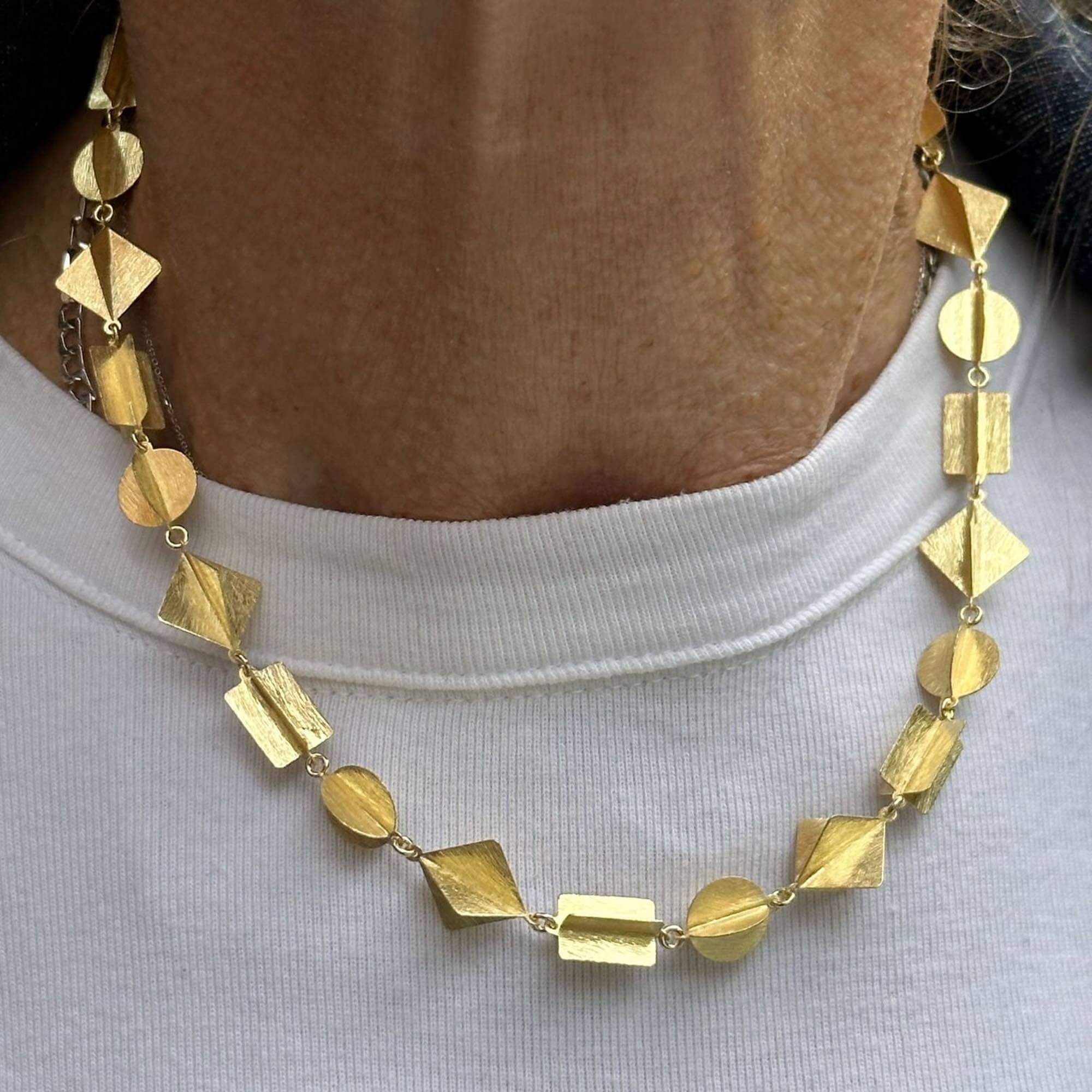 Multic-shaped necklace of gilded silver