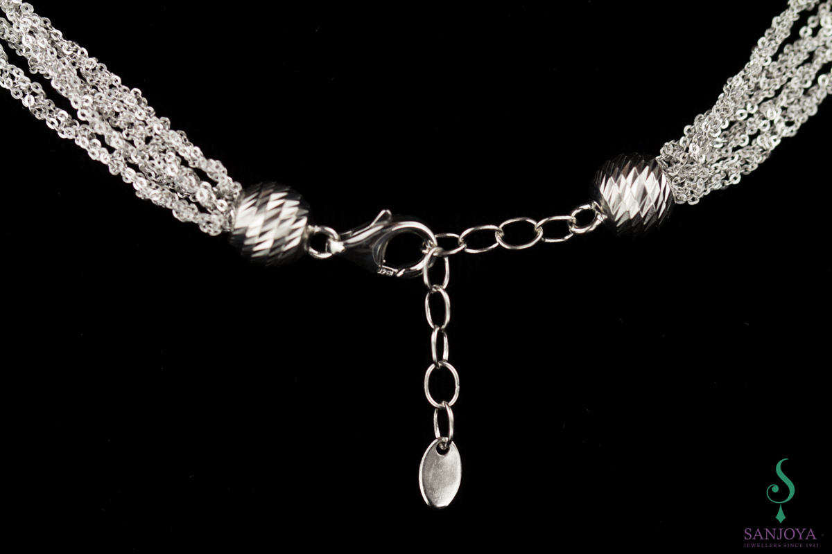 Four interwoven silver necklaces