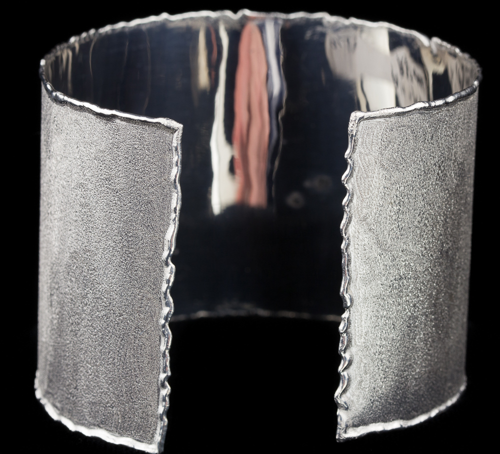 A robust silver cuff bangle in modern Italian design