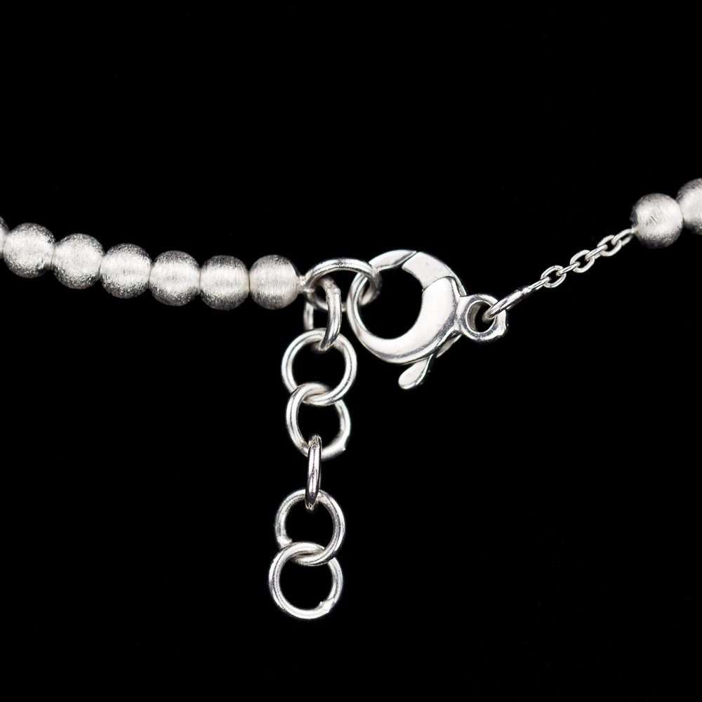 Silver necklace of smaller and larger balls