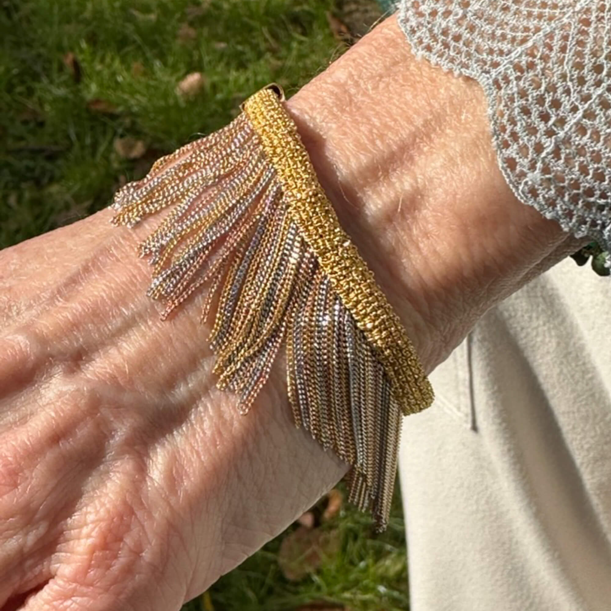 Three-colored silver bracelet with hanging chains