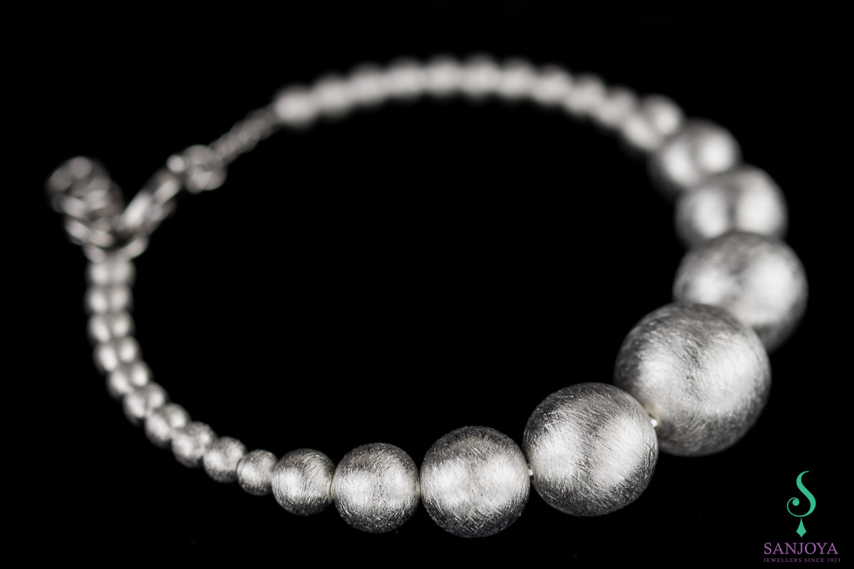 Silver bracelet with small and larger spheres