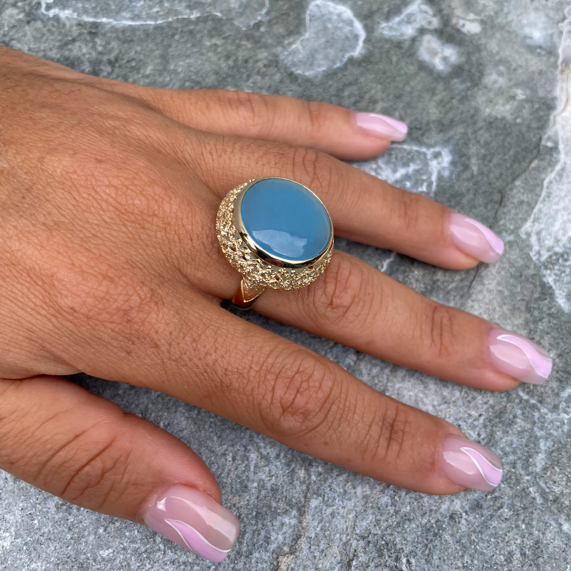 Decorated gold-plated ring with a blue quartz stone