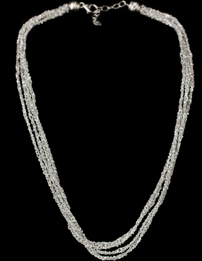 Four interwoven silver necklaces