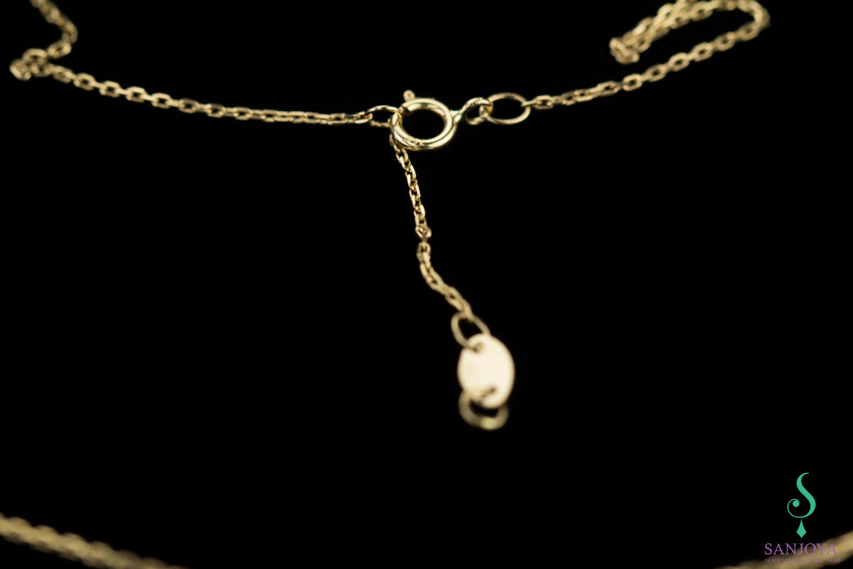 Gold chain with fine stick as pendant, 18 kt