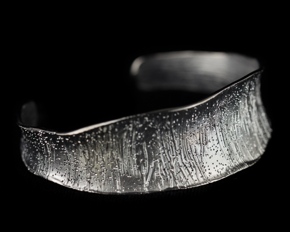 Thin gray silver bangle with flare