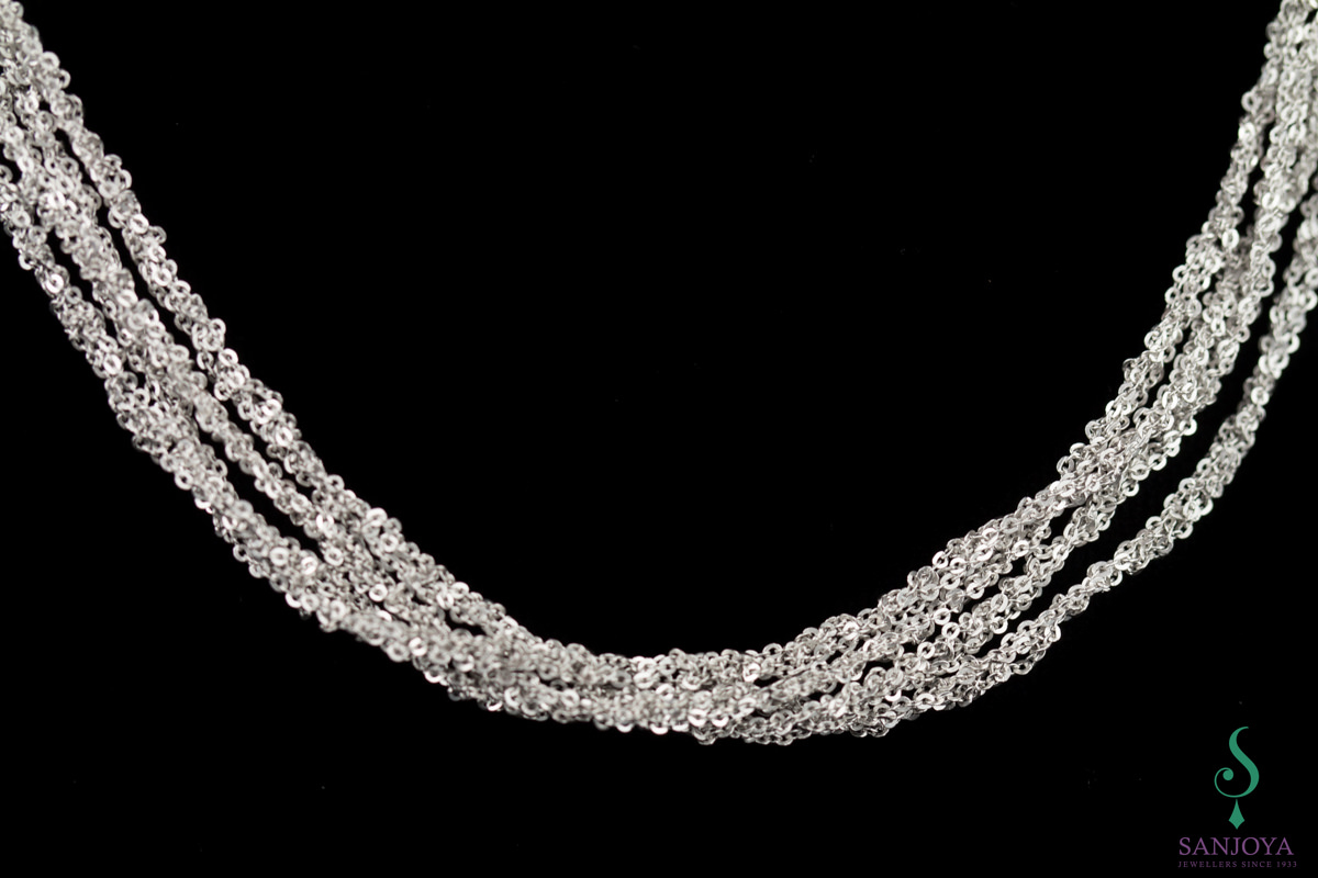 Four interwoven silver necklaces