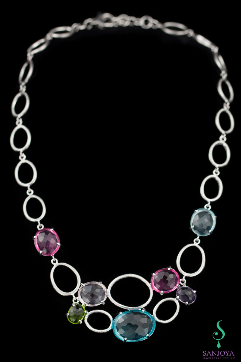 Processed silver necklace with colored stones