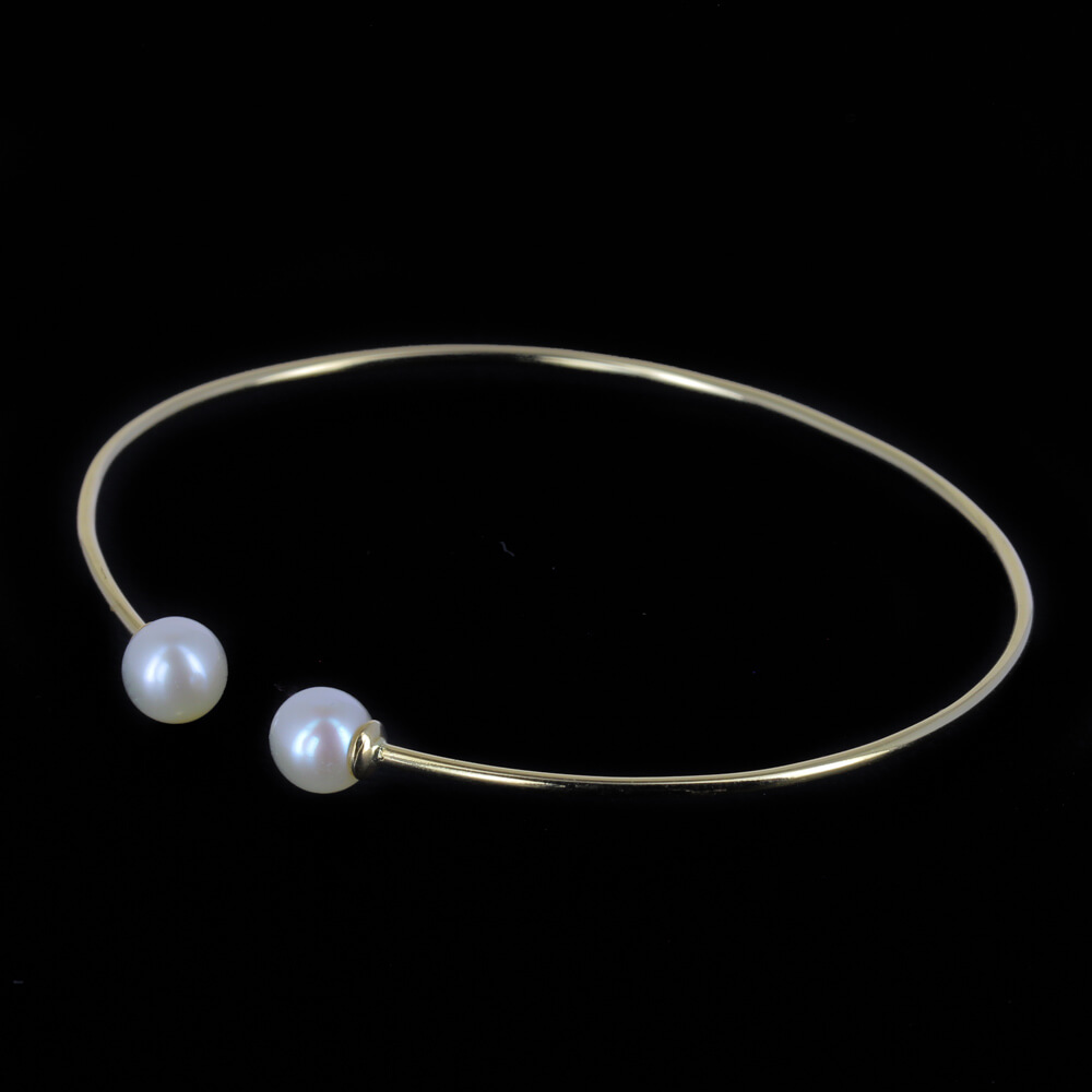 Refined gold open bracelet with pearl. 18 kt