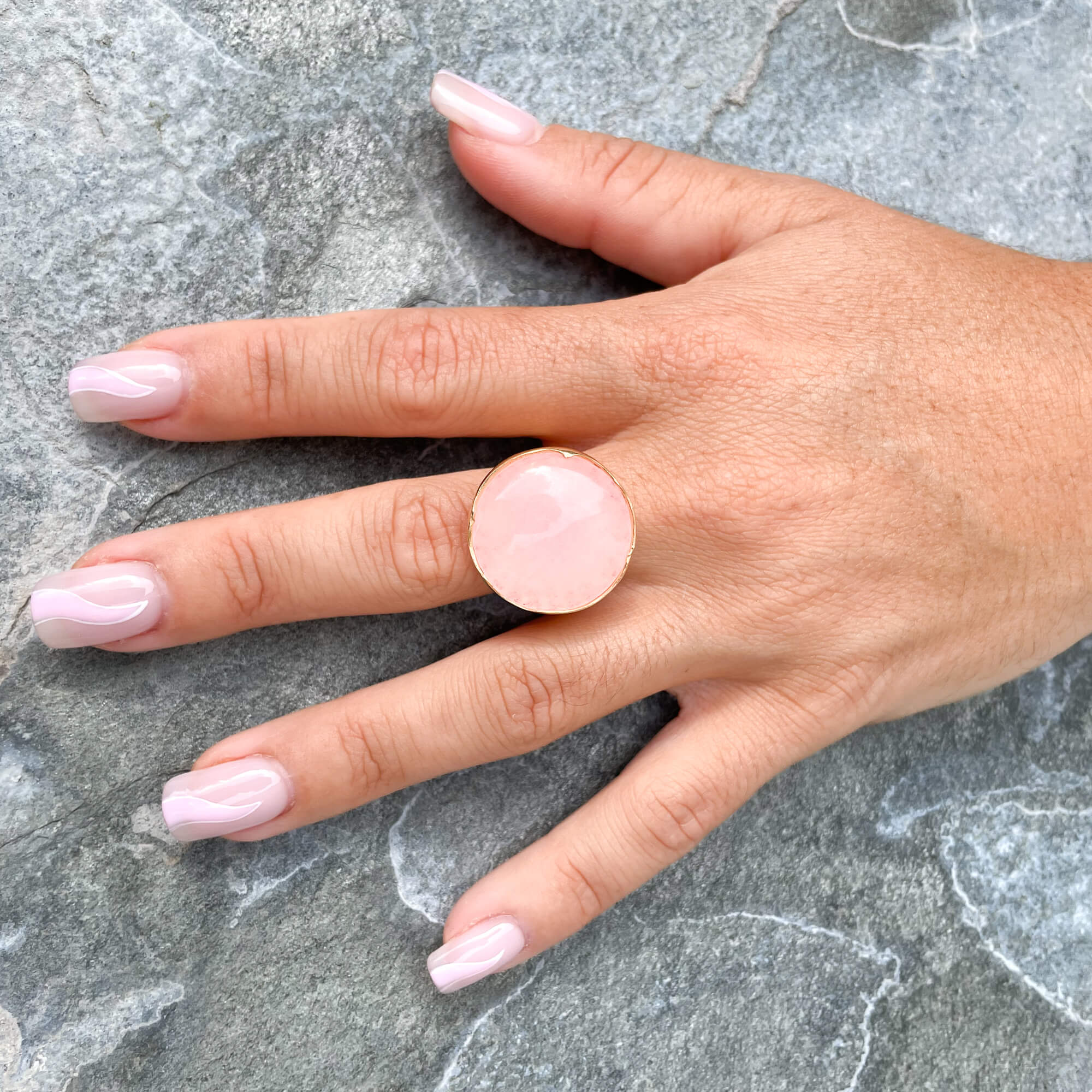 Gold-plated ring with a coral-colored quartz stone