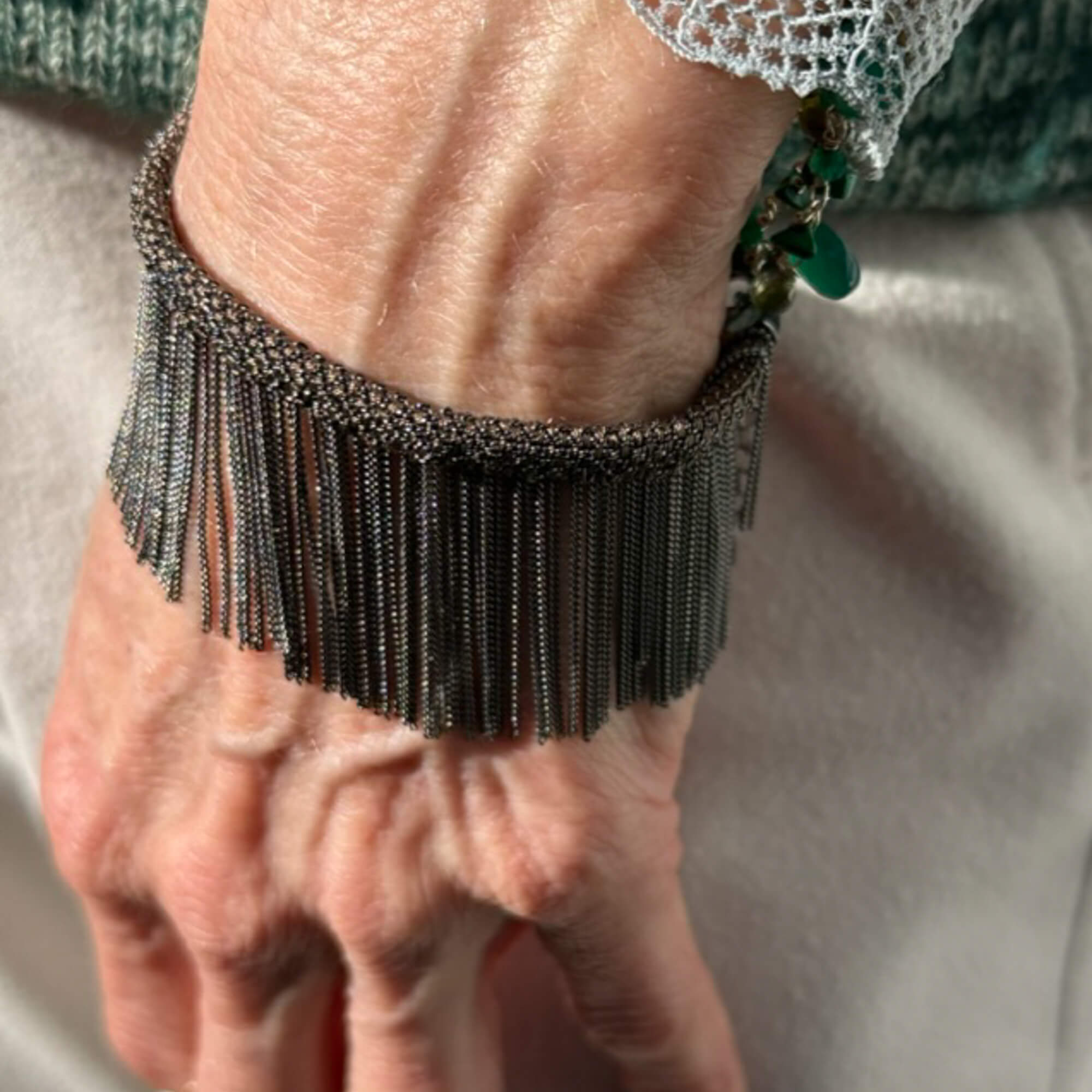 Brown and gray-colored bracelet with hanging chains