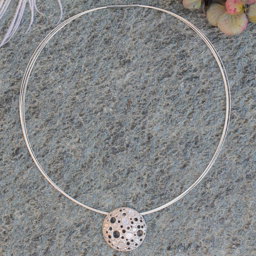 Silver pendant with irregular beautiful holes