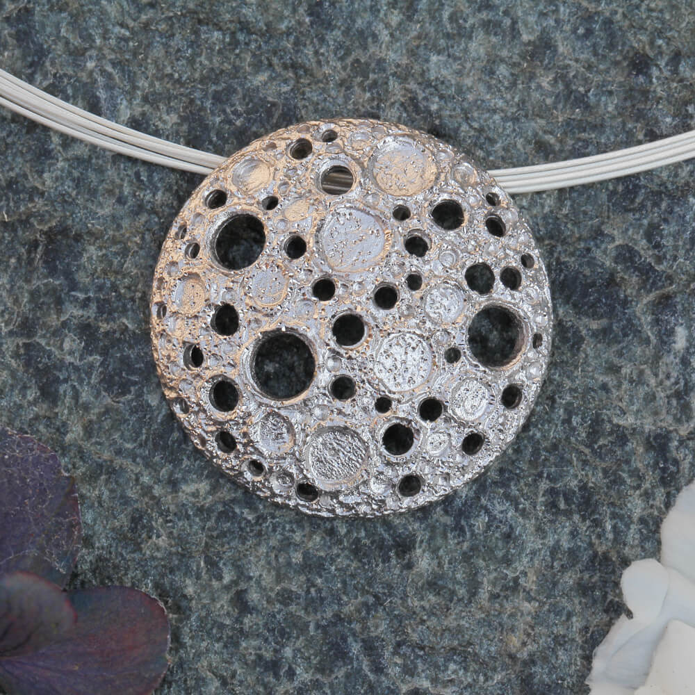 Silver pendant with irregular beautiful holes