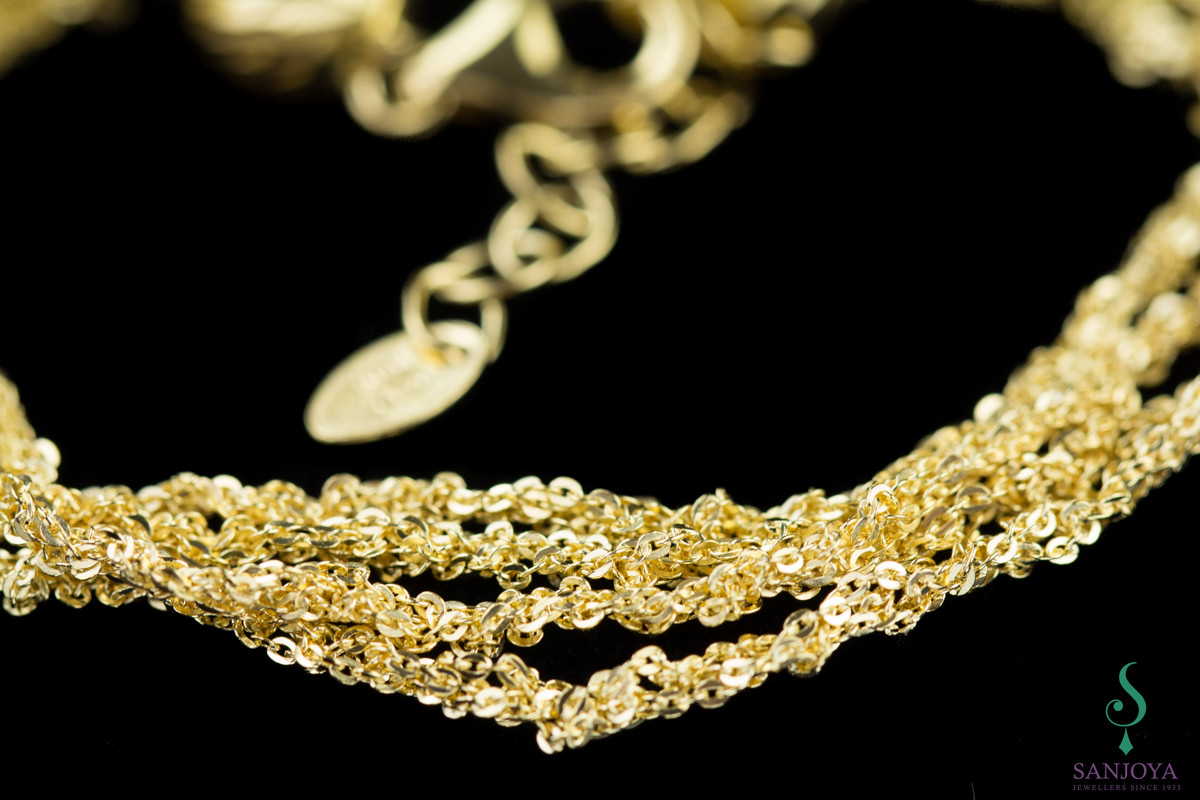 Four interwoven fine bracelets of gold plated silver