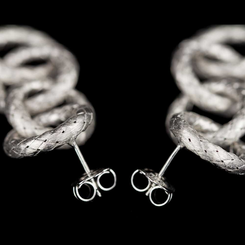 Silver earrings of open and round links