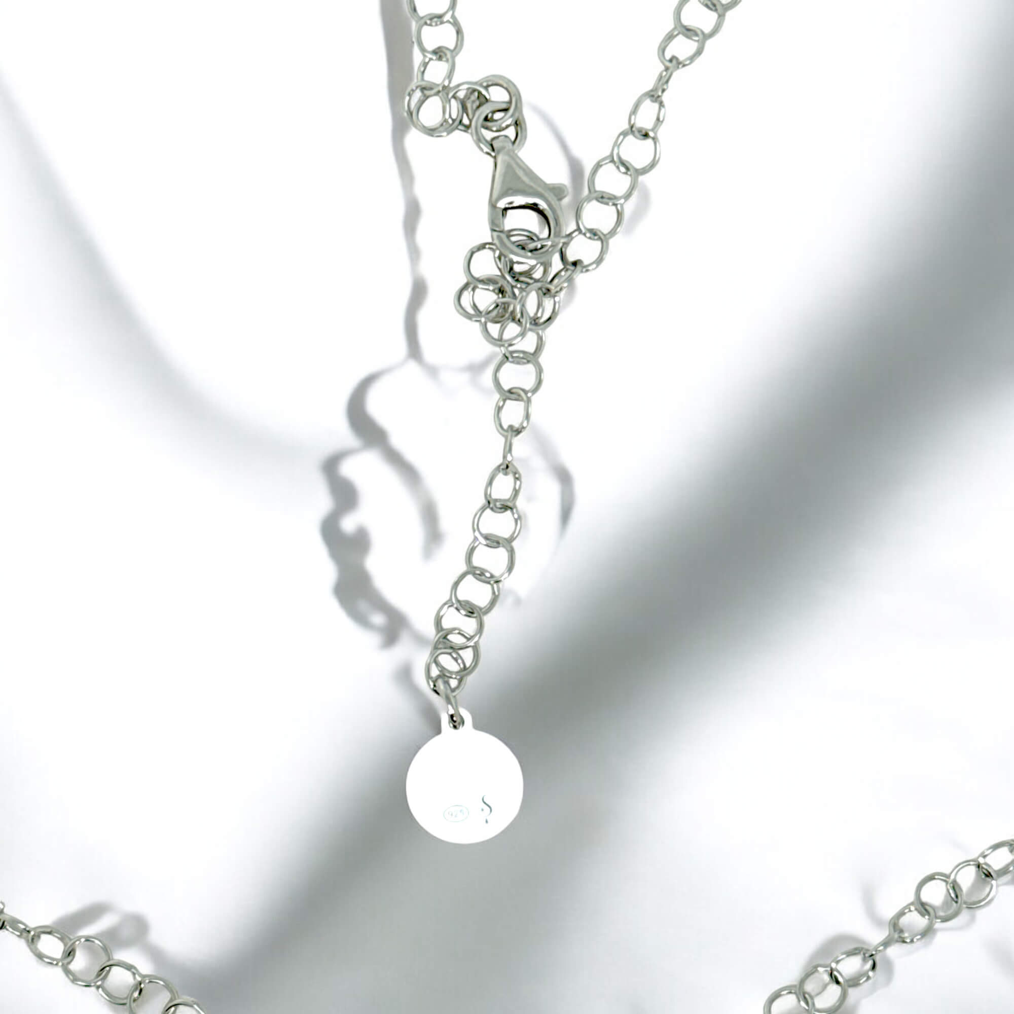 Circular silver pendant with chain