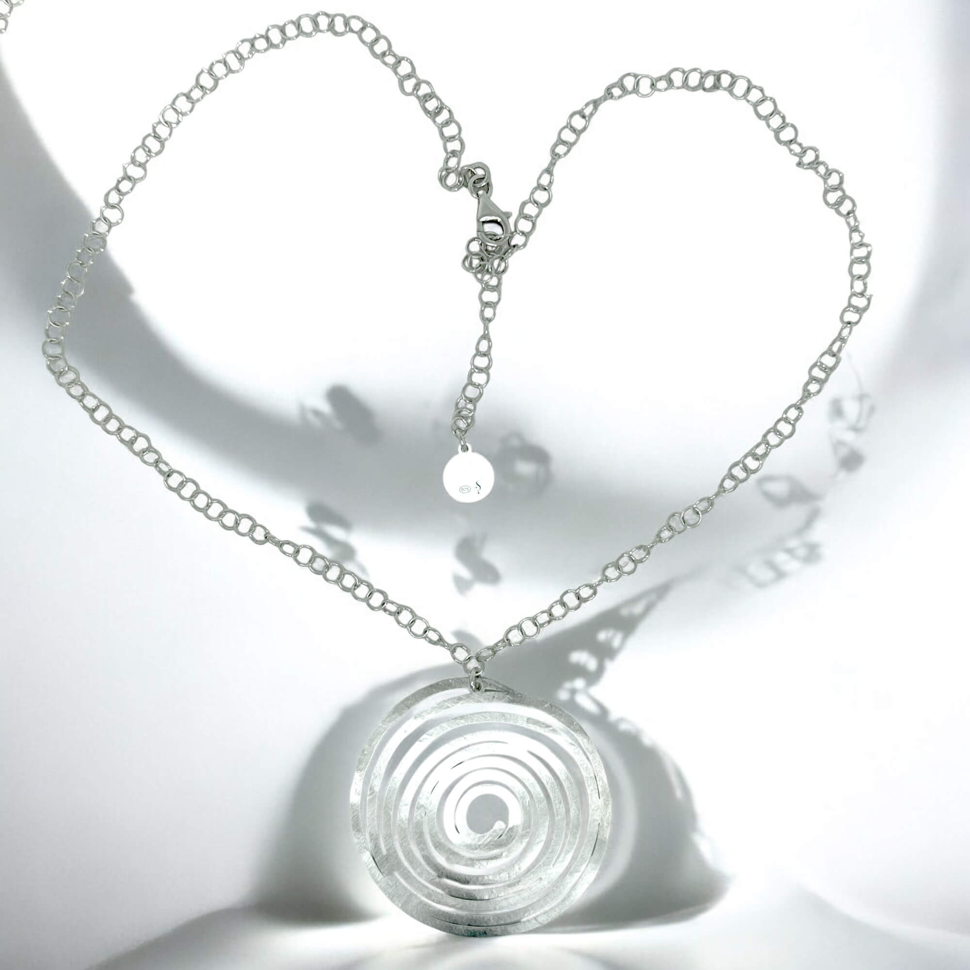 Circular silver pendant with chain