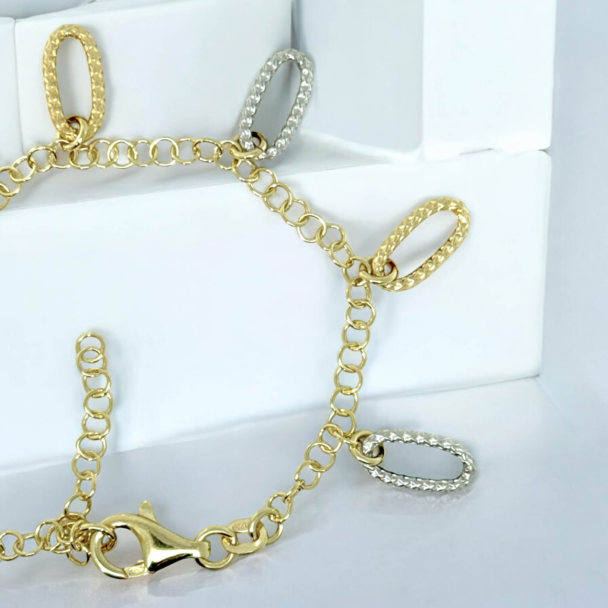 Decorated gold-plated bracelet with two-tone pendants