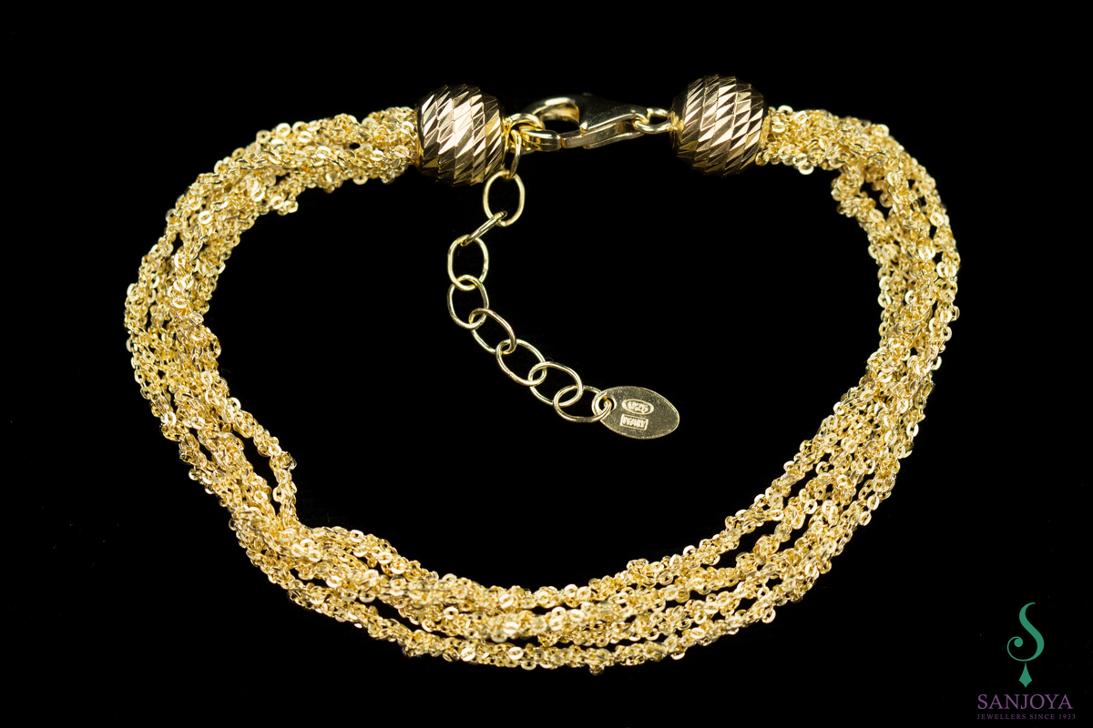 Four interwoven fine bracelets of gold plated silver