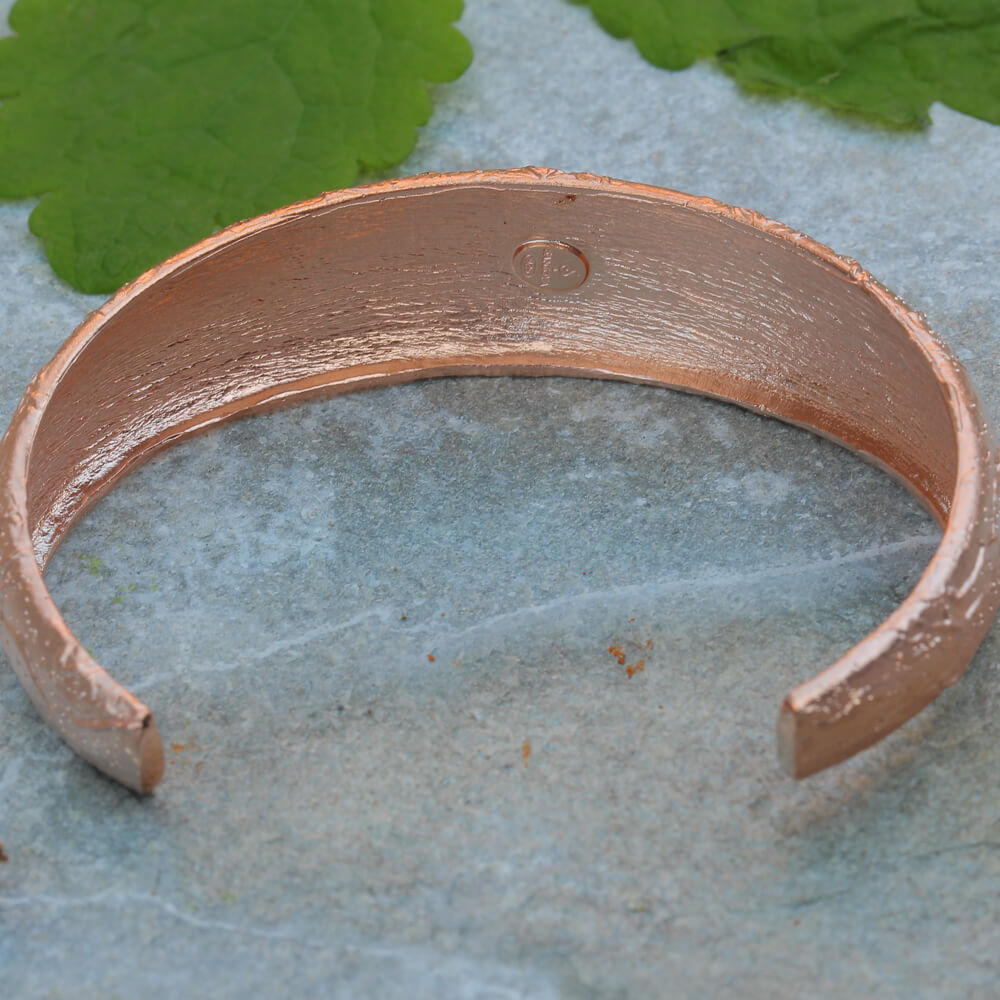 Processed, narrow, and diamond-tipped rosé bangle